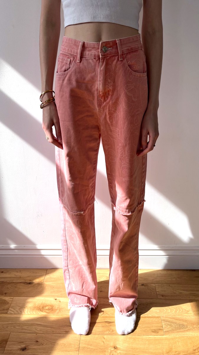 Coral pink print straight leg jeans with ripped knee